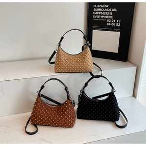 Detailed display of studded suede crescent bags in tan, caramel, and black colors