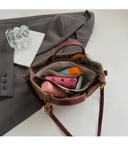 Interior view showing the large capacity and organized compartments of the brown leather bag