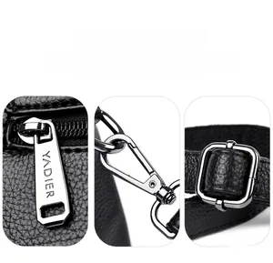 Detailed macro view of gunmetal hardware and YADIER zippers on black lychee leather bag