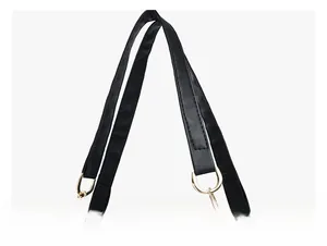Detail of premium black leather handle with golden metal rings and fine stitching