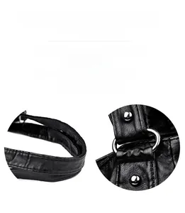 Detail of reinforced silver rings and stitching on black leather motorcycle tote bag