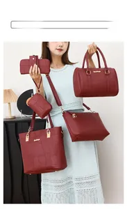 Close-up of six-piece burgundy handbag set with crocodile pattern and golden hardware