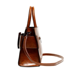 Brown leather large tote bag with side zipper and shoulder strap on white background