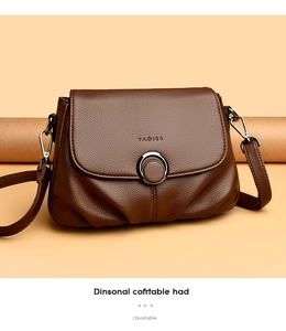 Detailed macro view of brown lychee grain leather texture and metallic ring buckle