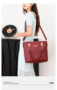 Burgundy tote bag featuring geometric embossed texture and gold hardware on a model