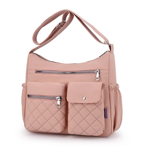 Pink high-capacity nylon crossbody bag with multiple pockets and adjustable strap