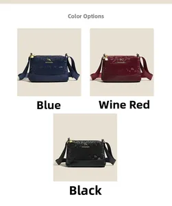 Detailed view of three textured Boston bags in navy, burgundy, and black with kangaroo logo