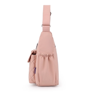 Pink nylon crossbody bag with large capacity, quilted front pocket and adjustable strap
