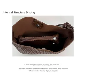 Internal view of brown woven bucket bag featuring magnetic closure and zipper inner pouch