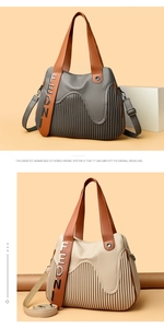 Détail de la texture plissée et du logo métallique FEDN sur le sac cabas à rayures