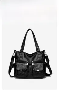 Front detail of a vintage black multi-pocket tote bag with washed leather texture