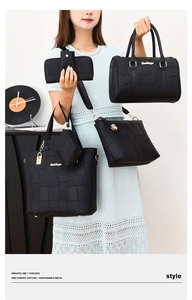 Detail shot of black 5-piece handbag set with crocodile pattern and gold hardware