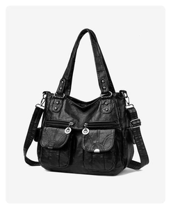 Detail of black faux leather tote with symmetric front pockets and silver hardware