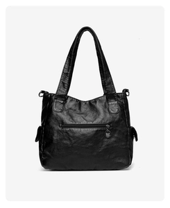 Detail of black vintage PU leather tote with front zipper pocket and side compartments
