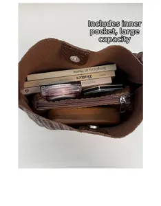 Detail view of woven shoulder bag showing spacious interior and removable zipper pouch