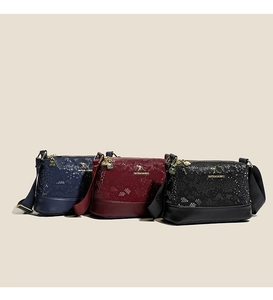 Detailed close-up of textured Boston bags in navy, burgundy, and black with golden kangaroo logo