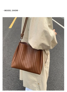 Detailed close-up of brown woven bucket bag with fine checkerboard texture on shoulder