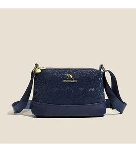 Detailed view of dark blue Boston bag with snake skin texture and gold hardware