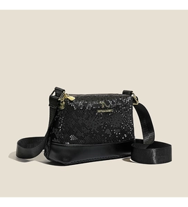 Macro detail of black faux-snakeskin texture and golden kangaroo logo on boston bag