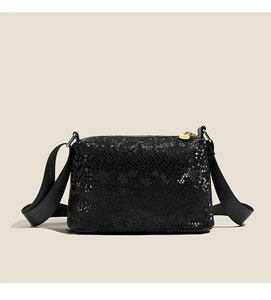 Detail of black faux leather Boston bag with snake skin texture and gold zippers