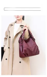 Detailed view of wine red PU leather tote bag with lychee texture and metal rivets