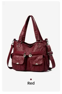 Detail view of red retro washed leather motorcycle bag with multi-pockets and soft texture