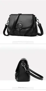 Detailed view of black lychee texture leather bag with elegant round metal lock clasp