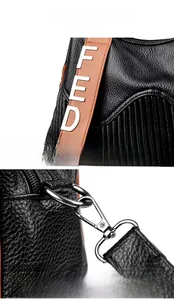 Détail du sac en cuir noir avec bandoulière marron et lettres FED en métal argenté