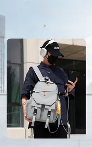 Front detail of gray business laptop backpack with functional pockets and buckle closure