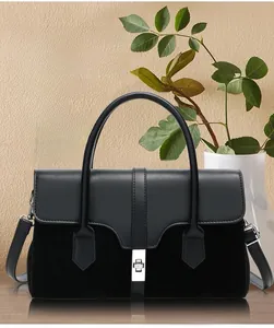 Detail of black vintage patchwork handbag with glossy leather and silver square twist lock