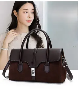Detail of vintage two-tone handbag with metal lock and large capacity interior