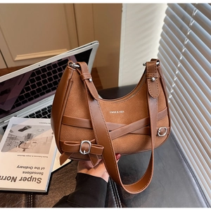 Vue détaillée du sac bandoulière en daim marron avec boucle argentée et sangle ajustable
