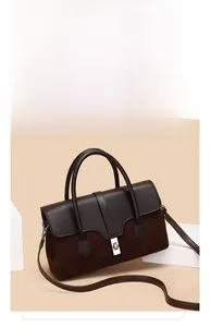 Detail of vintage tote showing dark brown leather splicing with suede and silver twist lock