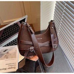 Détails d'un sac à bandoulière vintage en cuir marron avec sangles et boucles métalliques