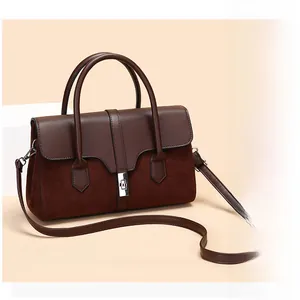 Detail of vintage coffee handbag showing contrast textures and silver twist lock