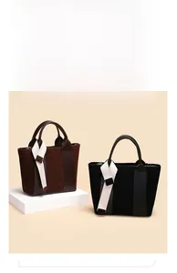 Detail of vintage bucket bags in brown and black with contrast ribbon on the handles