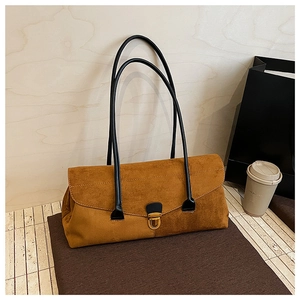 Detail of vintage brown suede Boston bag featuring golden twist lock and black straps