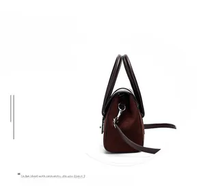 Detail view of the vintage brown shoulder bag showing textured material and metal buckle
