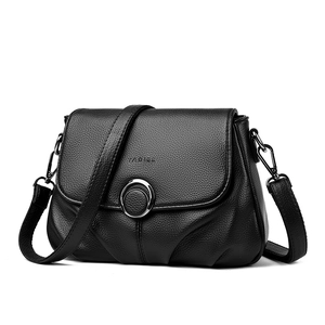 Classic black pebbled leather crossbody bag with silver metal ring and flap closure