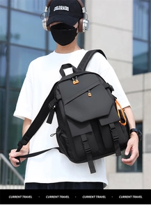 Detail view of a black multi-pocket laptop backpack with high-density waterproof fabric
