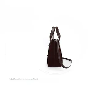 Side view of large brown bucket bag showing suede and smooth leather stitching detail