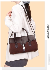 Detail view of large vintage shoulder bag with silver square buckle and suede stitching
