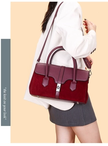 Detail of burgundy leather and suede contrast stitching with silver metal twist lock