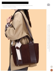 Detail of chocolate brown bucket bag featuring contrast stitching and suede textures
