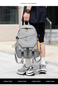 Detail of light gray tactical backpack with orange accents and functional buckles