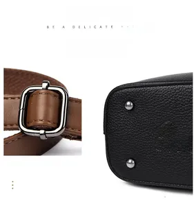 Detail of adjustable leather strap and bottom studs on a pebbled tote bag