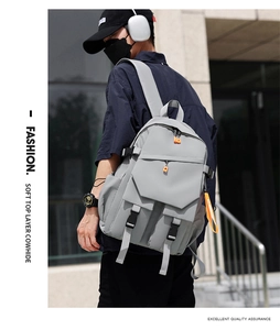 Close-up of grey laptop backpack showing soft top layer cowhide texture and orange zipper