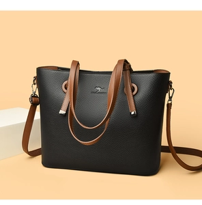 Detail of black lychee grain leather tote with brown straps and kangaroo logo engraving