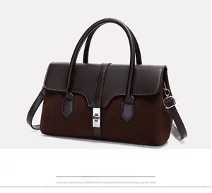 Detail of color-block tote bag with suede texture and silver twist-lock closure