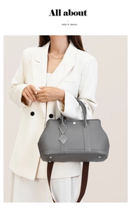Detail of grey litchi grain leather tote with fabric strap and metallic diamond charm
